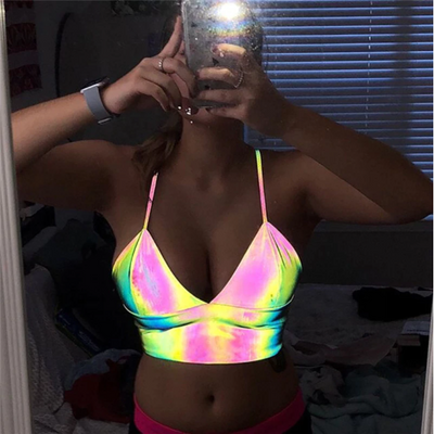 A rave girl wearing reflective crop top for raves or music festivals.