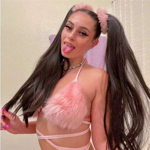 A woman wearing fluufy fur pink bra for raves.