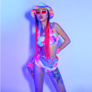 A rave girl wearing tie dye bikini two piece set with accessories for raves.