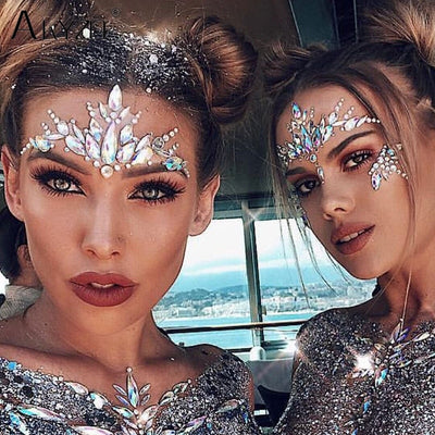 Two women wearing sparkly rhinestone face jewels for music festivals.