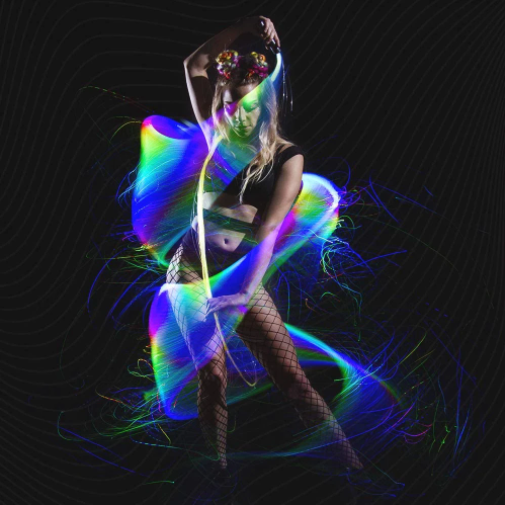 A woman dancing with LED color changing fiber optic whip for raves.