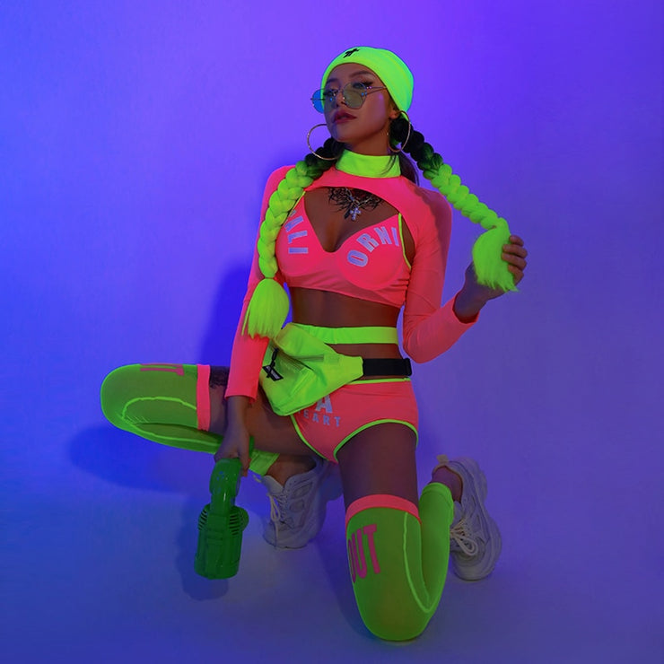 A woman wearing neon cheerleader costume two piece set with accessories for raves.