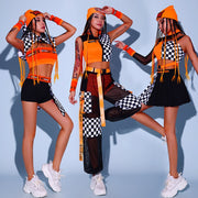 Rave girls wearing orange and black hip hop two piece sets to a rave or music festival.