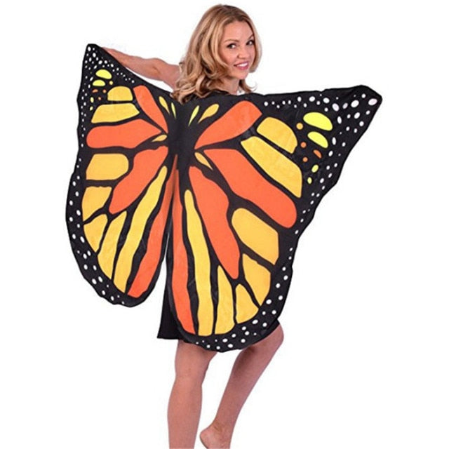 A rave girl wearing rave butterfly wings accessory at a music festival.