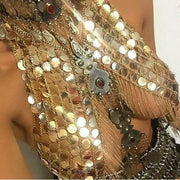 A woman wearing gold sequin metal chain crop top for raves or music festivals.
