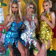 A group of women wearing sequin low cut backless dresses at raves or music festival.