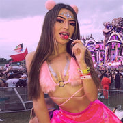 A woman wearing fluufy fur pink bra for raves at a music festival.