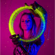 A woman holding LED color changing fiber optic whip for raves.