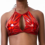 A rave girl wearing red holographic crop top to a rave or music festival.
