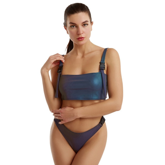 A woman wearing reflective rave bikini two piece set.
