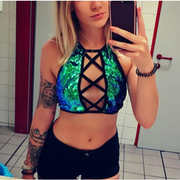 A rave girl wearing hollow out and backless sequin crop top to a rave or music festival.