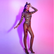 A woman wearing sexy leopard bodysuit with tail for raves.