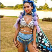 A rave girl wearing rave butterfly wings accessory at a music festival.