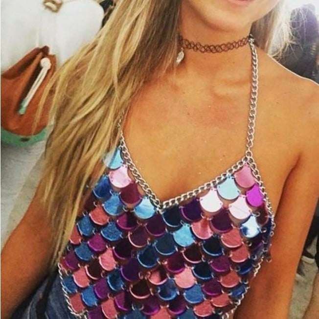 A rave girl wearing colorful sequin halter crop top for raves or music festivals.
