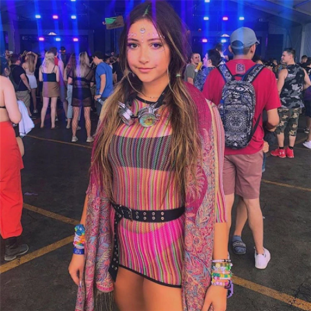 A rave girl wearing mesh dress at a music festival