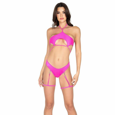A woman wearing hot pink underboob cutout tie top and gartered clip-on shorts for raves.